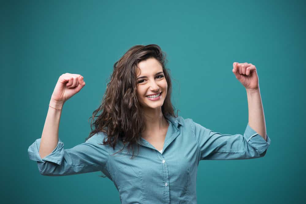 energized happy woman raised hands